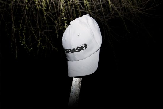White baseball cap with bold logo mockup on dark background, ideal for designers creating branding presentations.
